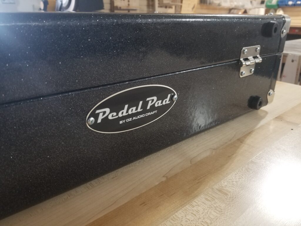 The back of a Pedal Pad pedal board displaying the Pedal Pad logo