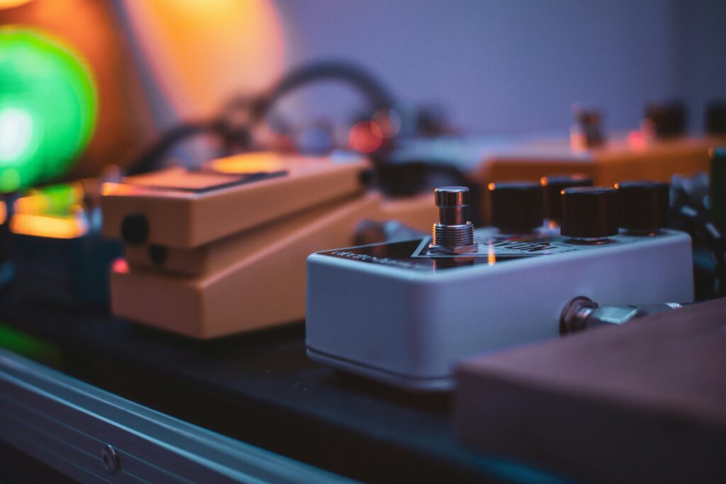 a closeup of some guitar effects pedals on a pedal board