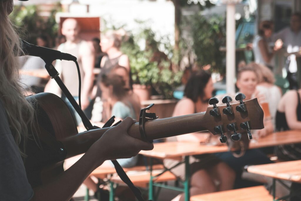 An acoustic guitar player performing in front of a live audience